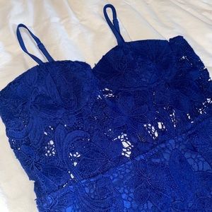 Blue lace romper with adjustable straps and zip back